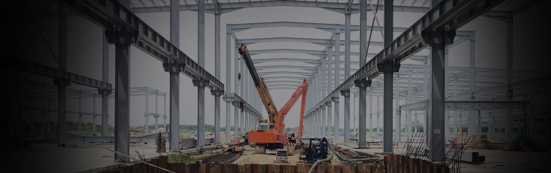 Steel-frame warehouse construction with excavators